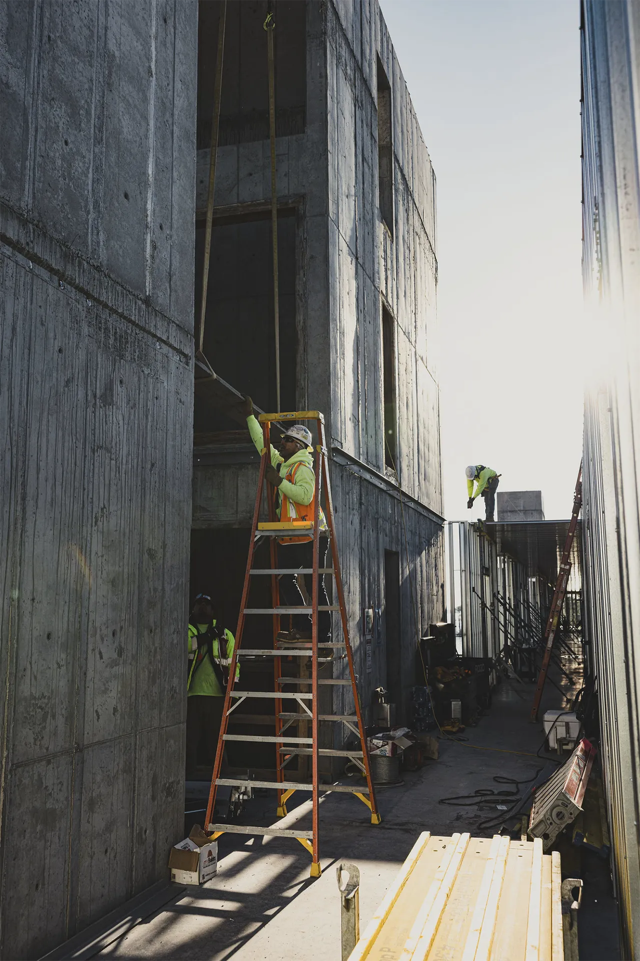 Construction crew working across multiple levels of an active project