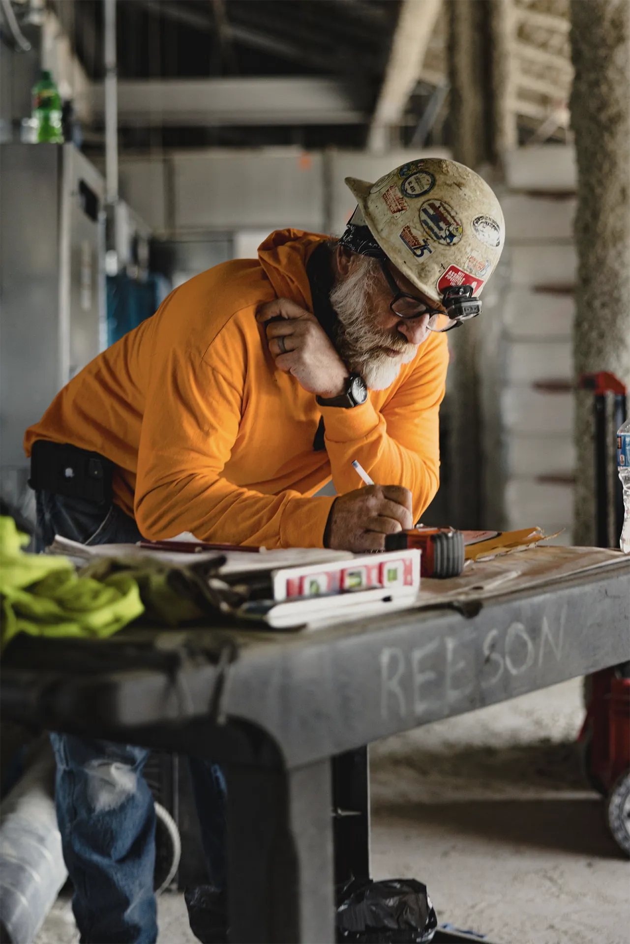 Reeson reviewing plans inside an active construction project